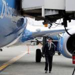 First officer Robb Crawford, a pilot for Alaska Airlines, does a pre-flight inspection of a Boeing 737-800 on Oct. 7 at Seattle-Tacoma International Airport. (AP Photo/Ted S. Warren)