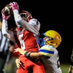 Marysville Pilchucks Dillon Kuk makes a reception over Ferndales Thomas Broselle Friday night at Quil Ceda Stadium in Marysville. (Kevin Clark / The Herald)