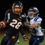 Granite Falls Cole Corbin tries to escape a tackle by Sultans Aidan Fleming during a game on Friday in Granite Falls. (Olivia Vanni / The Herald)