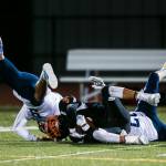 Two Sultan players collide while tackling Granite Falls Mason McBride during the game on Friday in Granite Falls. (Olivia Vanni / The Herald)