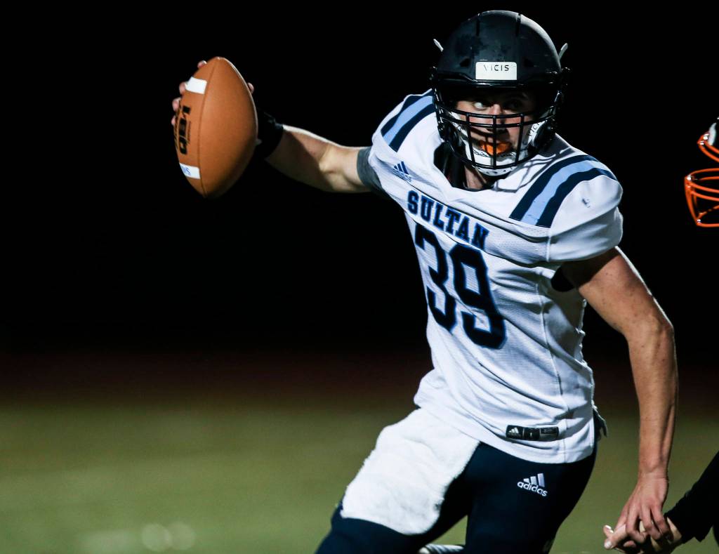 Sultans Willy Bennett runs to escape a tackle during a game against Granite Falls on Friday in Granite Falls. (Olivia Vanni / The Herald)