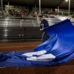 A student folds up the Sultan High School flag during a game against Granite Falls on Friday in Granite Falls. (Olivia Vanni / The Herald)