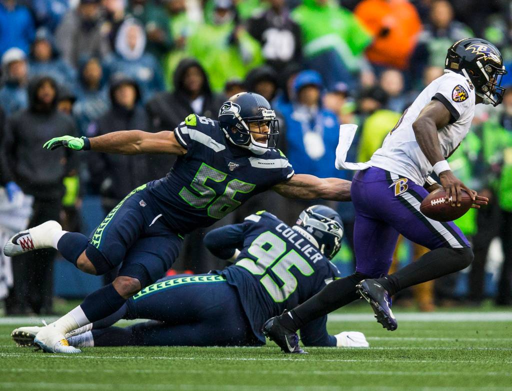Seattle Seahawks Mychal Kendricks reaches out to try and tackle Baltimore Ravens Lamar Jackson during the game against the Baltimore Ravens on Sunday, Oct. 20, 2019 in Seattle, Wash. (Olivia Vanni / The Herald)