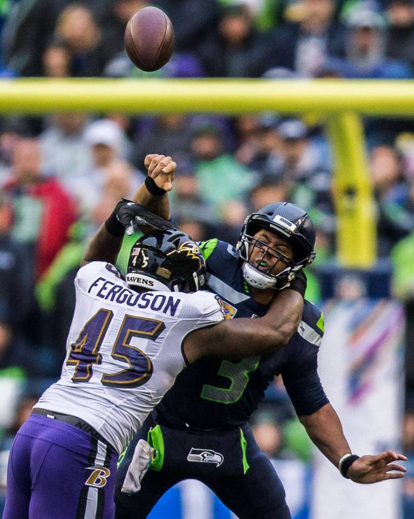 Seattle Seahawks Russell Wilson is tackled by Baltimore Ravens Jaylon Ferguson during the game against the Baltimore Ravens on Sunday, Oct. 20, 2019 in Seattle, Wash. (Olivia Vanni / The Herald)