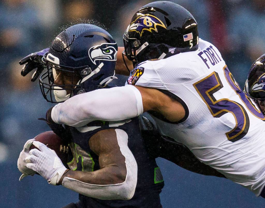 Seattle Seahawks Chris Carson is tackled by Baltimore Ravens L.J. Fort during the game against the Baltimore Ravens on Sunday, Oct. 20, 2019 in Seattle, Wash. (Olivia Vanni / The Herald)