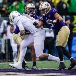 Oregon Ducks quarterback Justin Herbert runs between two Husky players for a touchdown during the game against Oregon on Saturday, Oct. 19, 2019 in Seattle, Wash. (Olivia Vanni / The Herald)