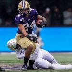 Washington Huskies Kamari Pleasant is tackled during the game against Oregon on Saturday, Oct. 19, 2019 in Seattle, Wash. (Olivia Vanni / The Herald)