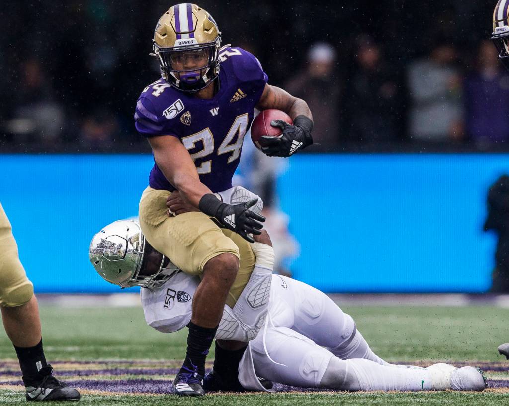 Washington Huskies Kamari Pleasant is tackled during the game against Oregon on Saturday, Oct. 19, 2019 in Seattle, Wash. (Olivia Vanni / The Herald)