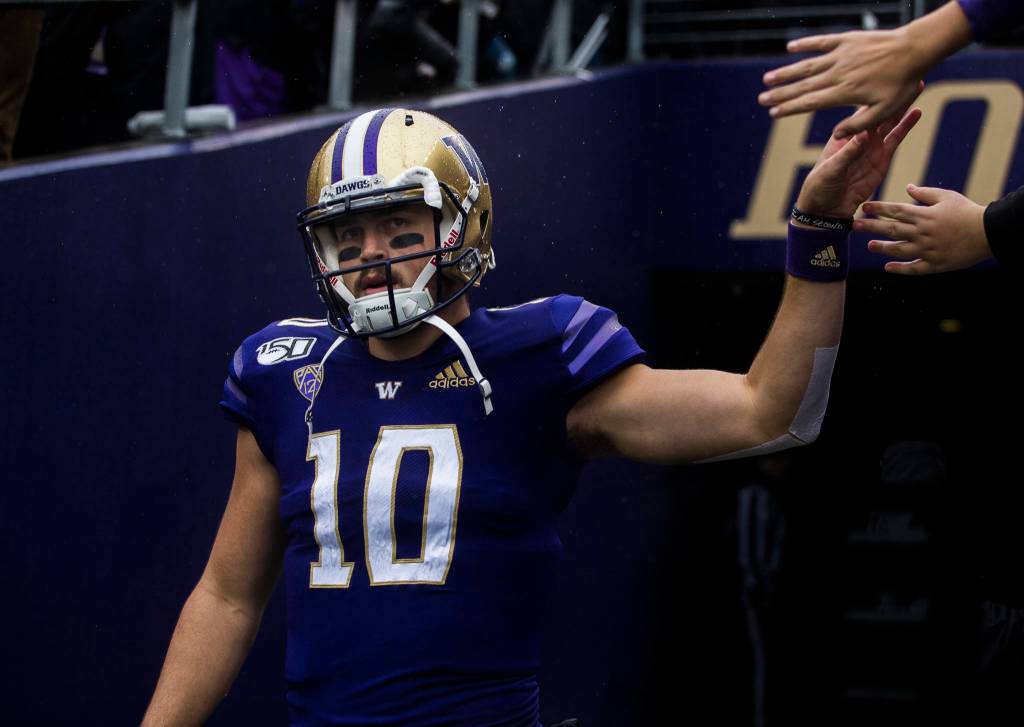 Washington Huskies quarterback Jacob Eason his fives fan as he walk out onto the field before the game against Oregon on Saturday, Oct. 19, 2019 in Seattle, Wash. (Olivia Vanni / The Herald)