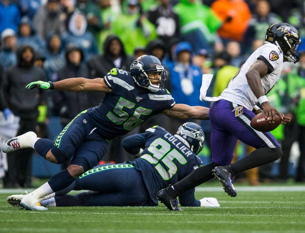 Seattle Seahawks Mychal Kendricks reaches out to try and tackle Baltimore Ravens Lamar Jackson during the game against the Baltimore Ravens on Sunday, Oct. 20, 2019 in Seattle, Wash. (Olivia Vanni / The Herald)