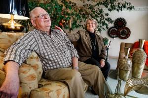 Relaxing on a comfortable couch near their living ficus tree, Bob and Jeanne Van Winkle share laughter while talking about their life in the furniture business. (Dan Bates / The Herald)