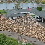 The house is barely visible behind Shane McDaniels woodpile in Lake Stevens. (Chuck Taylor / The Herald)