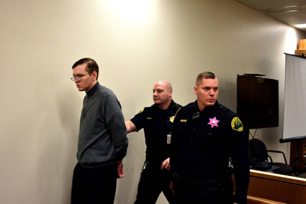 Anthony Garver is led out of the courtroom at break in his testimony Friday in Snohomish County Superior Court. (Caleb Hutton / The Herald)