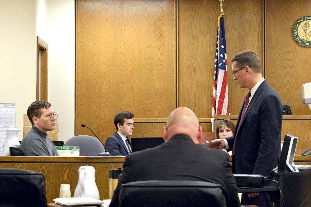 Deputy prosecutor Matt Hunter cross-examines Anthony Garver (left) during his murder trial Friday in Snohomish County Superior Court. (Caleb Hutton / The Herald)