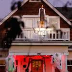 In a terrifying scene borrowed from the horror film The Omen, a mannequin stands on the second-floor balcony rail of a house on Everetts Hoyt Avenue. (Dan Bates / The Herald)