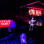 Dubbed Fowler Manor, Aaron and Dani Ackerts home on Fowler Avenue in Everett features a graveyard with 30 tombstones where the dead are definitely not resting in peace. Their sons, Daxton and Kruz helped set up the spooky scene, which has colored strobe lights and fog machines. (Dan Bates / The Herald)