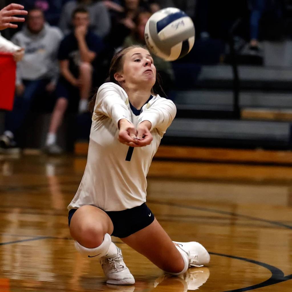 Arlingtons Taylor Helle passes against Oak Harbor Thursday evening at Arlington High School on October 24, 2019. Arlington won in straight sets. (Kevin Clark / The Herald)