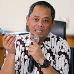 National Transportation Safety Committee investigator Nurcahyo Utomo holds a model of an airplane during a press conference in Jakarta, Indonesia, on Friday. (AP Photo/Tatan Syuflana)