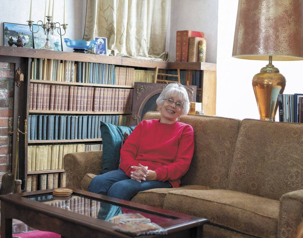 Oysterville writer and historian Sydney Stevens sits in her living room. (Photo by Patricia Jollimore)