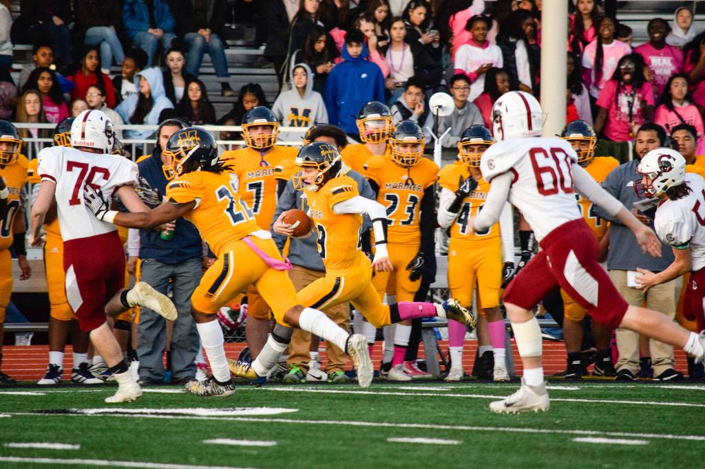 Junior quarterback Jackson Cole runs for a first down against Cascade on Friday, Oct. 25 at Goddard Stadium in Everett. (Katie Webber / The Herald)