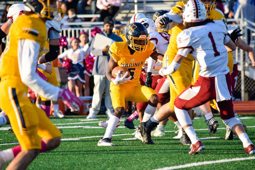 Senior running back Prince Riley runs towards the Cascade defense on Friday, Oct. 25 at Goddard Stadium in Everett. (Katie Webber / The Herald)