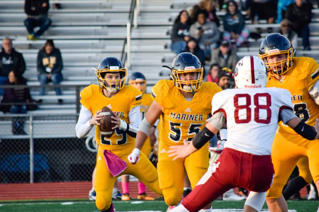 Junior quarterback Jackson Cole looks for an open receiver against Cascade on Friday, Oct. 25 at Goddard Stadium in Everett. (Katie Webber / The Herald)