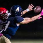 Marysville Pilchucks Jordan Justice (left) deflects a pass away from Arlingtons Joseph Schmidt during a Wesco 3A North game on Friday at John C. Larson Stadium in Arlington. Marysville Pilchuck beat Arlington 42-14 to win the Wesco 3A North title. (Olivia Vanni / The Herald)