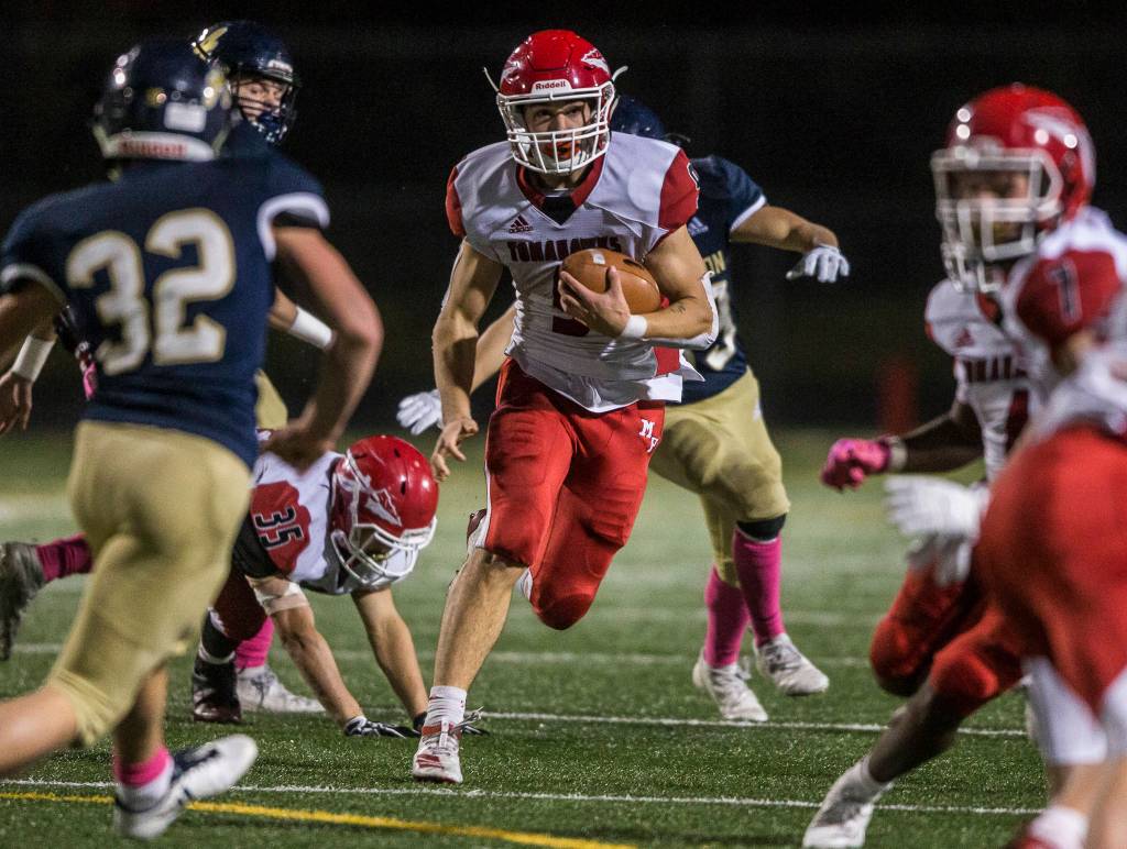 Marysville Pilchucks Jordan Justice runs through the Arlington defense during a Wesco 3A North game on Friday at John C. Larson Stadium in Arlington. Marysville Pilchuck beat Arlington 42-14 to win the Wesco 3A North title. (Olivia Vanni / The Herald)