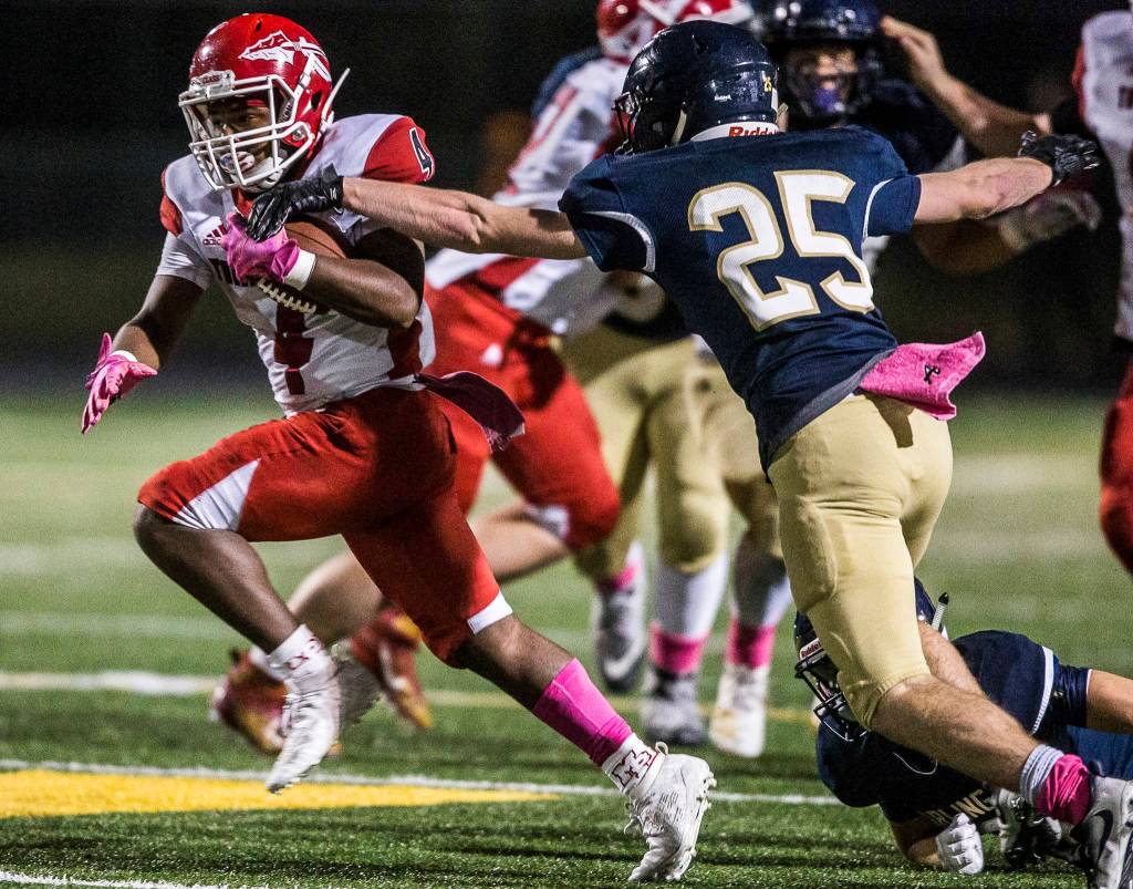 Marysville-Pilchucks Jay Gray breaks through a tackle during the game on Oct. 25, 2019 in Arlington, Wash. (Olivia Vanni / The Herald)