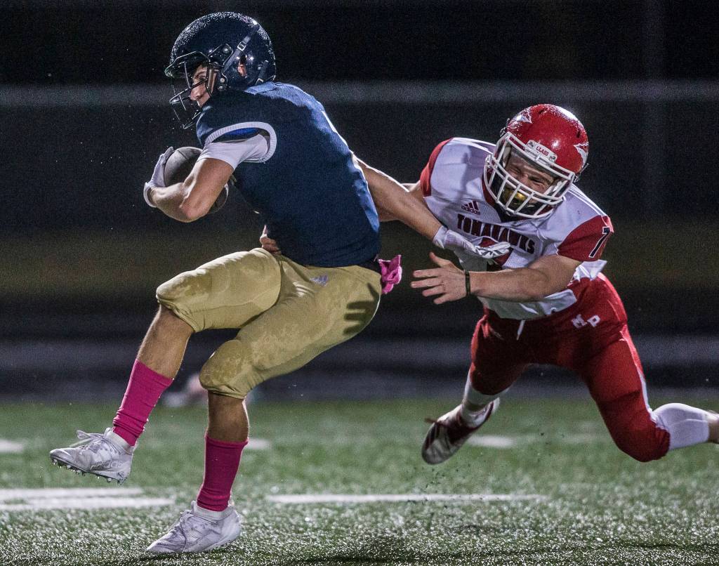 Arlingtonճ Cade Younger is tackled by Marysville-Pilchuckճ Kyle Nyblod during the game on Oct. 25, 2019 in Arlington, Wash. (Olivia Vanni / The Herald)