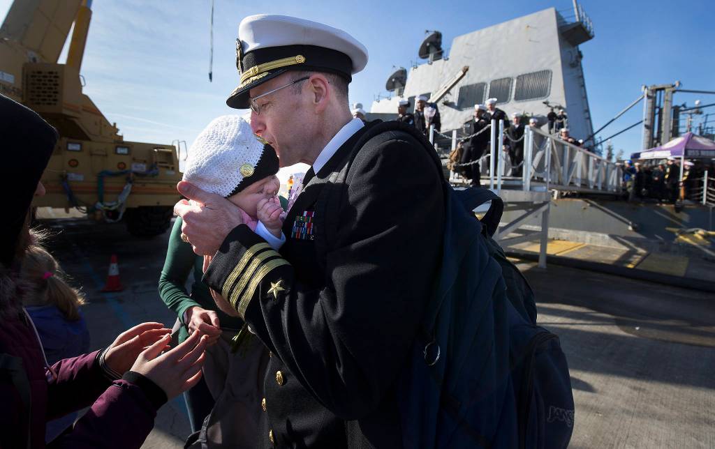 Cmdr. Robert Laird greets his three-month old daughter, Agnes, for the first time as the USS Momsen returns Monday to Naval Station Everett. (Andy Bronson / The Herald)                                Commander Robert Laird greets his three-month-old daughter Agnes for the first time as the USS Momsen (DDG-92) returns to Naval Station Everett after a deployment to the Pacific on Monday in Everett. (Andy Bronson / The Herald)