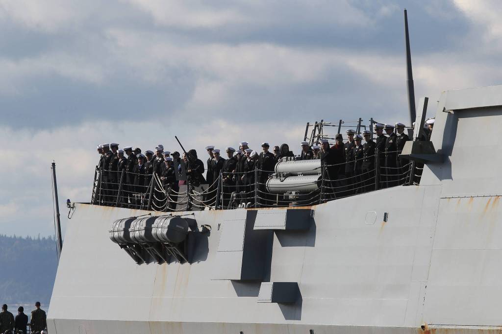 Families and friends wait to greet sailors from the USS Momsen (DDG-92) as it returns to Naval Station Everett after a deployment to the Pacific on Monday in Everett. (Andy Bronson / The Herald)