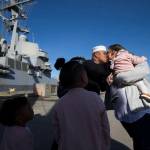 Melchor Moises kisses his wife, Kanoe Moises, on Monday at Naval Station Everett after winning the first kiss in a raffle drawing. He was the first to walk off the USS Momsen after six months of deployment. (Andy Bronson / The Herald)                                Melchor Moises is the first to disembark the USS Momsen and kisses his wife, Kanoe Moises, after winning the First Kiss raffle drawing at Naval Station Everett on Monday in Everett. (Andy Bronson / The Herald)