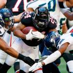 Seattles Bobby Wagner (left) reaches out to tackle Atlantas Devonta Freeman (24) during the Seahawks win over the Falcons on Sunday in Atlanta. (AP Photo/John Bazemore)