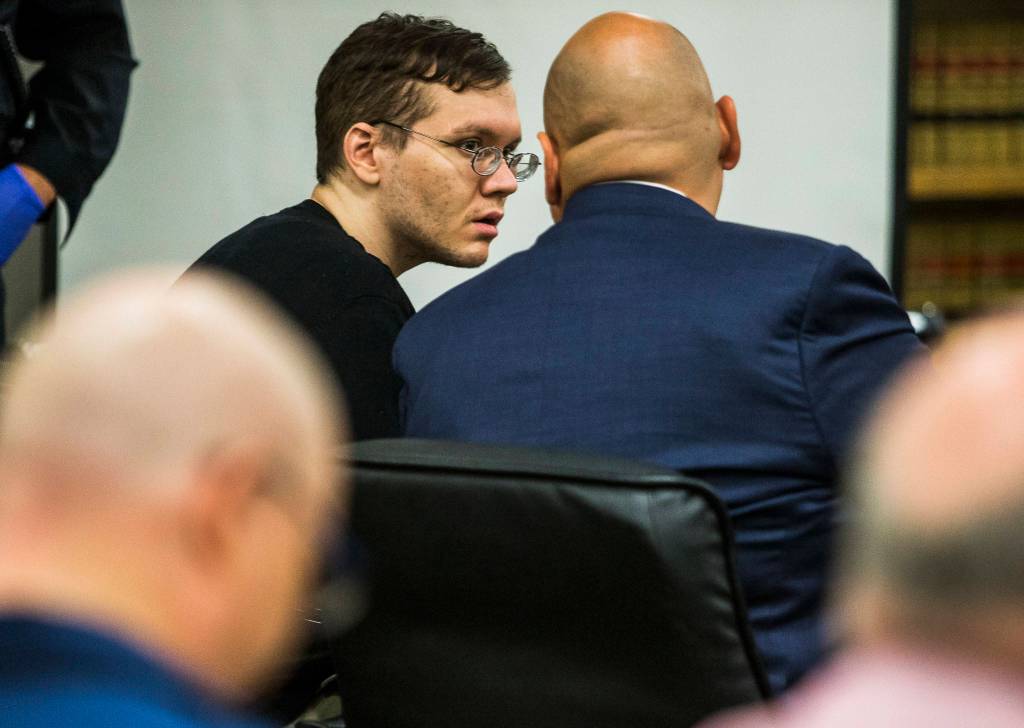 Anthony Garver talks with his attorney as the judge reads his remarks before the verdict at the Snohomish County Courthouse on Tuesday in Everett. (Olivia Vanni / The Herald)