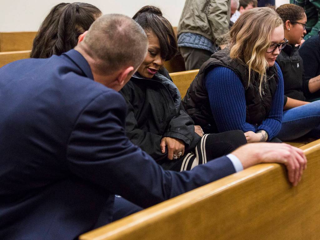 Olivia Vanni / The Herald                                 Detective Brad Walvatne talks with Kris Evans, mother of Phillipa Evans-Lopez, at the Snohomish County Courthouse on Tuesday.