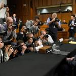 Boeing Company President and Chief Executive Officer Dennis Muilenburg (right) is surrounded by photographers on Capitol Hill in Washington on Tuesday, before the start of a Senate Committee on Commerce, Science, and Transportation hearing on Aviation Safety and the Future of Boeings 737 MAX. (AP Photo/Susan Walsh)