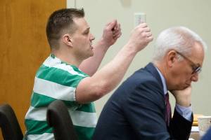 Harry Nettleton IV speaks to the judge while defense attorney Donald Wackerman listens in Snohomish County Court on Monday in Everett. (Andy Bronson / The Herald)