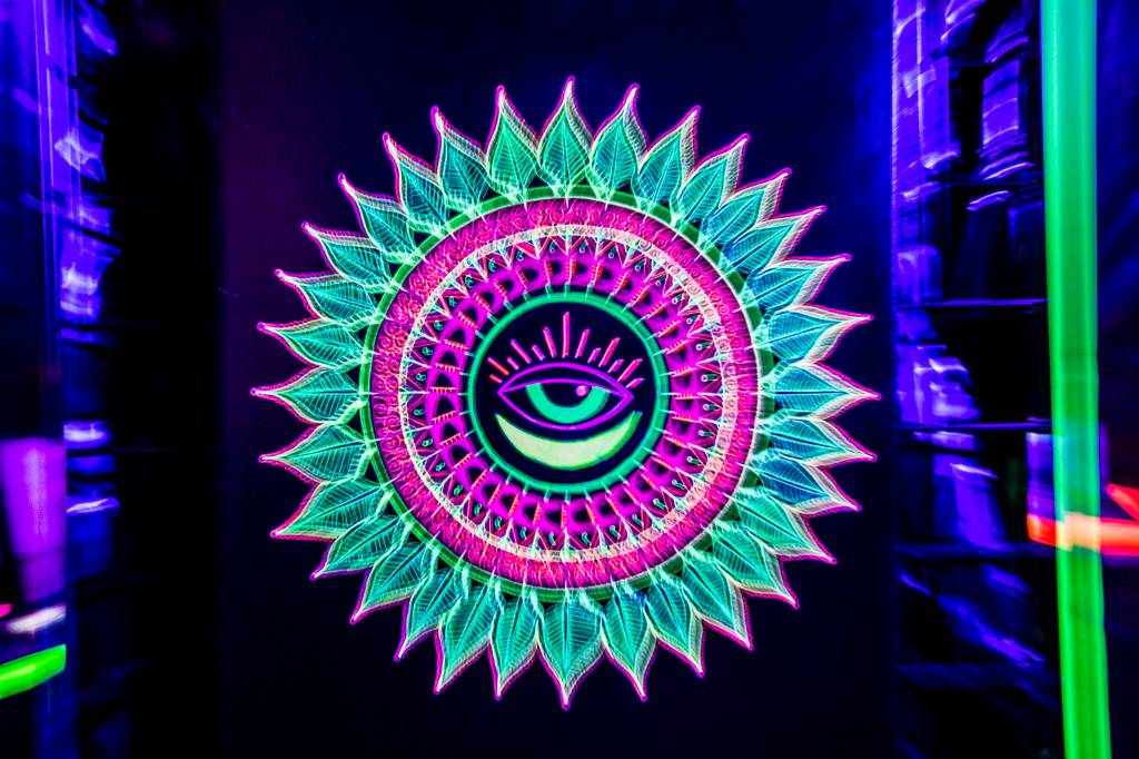 A fluorescent painting on display in a black-light gallery at JAG Artworks in Everett. (Olivia Vanni / The Herald)