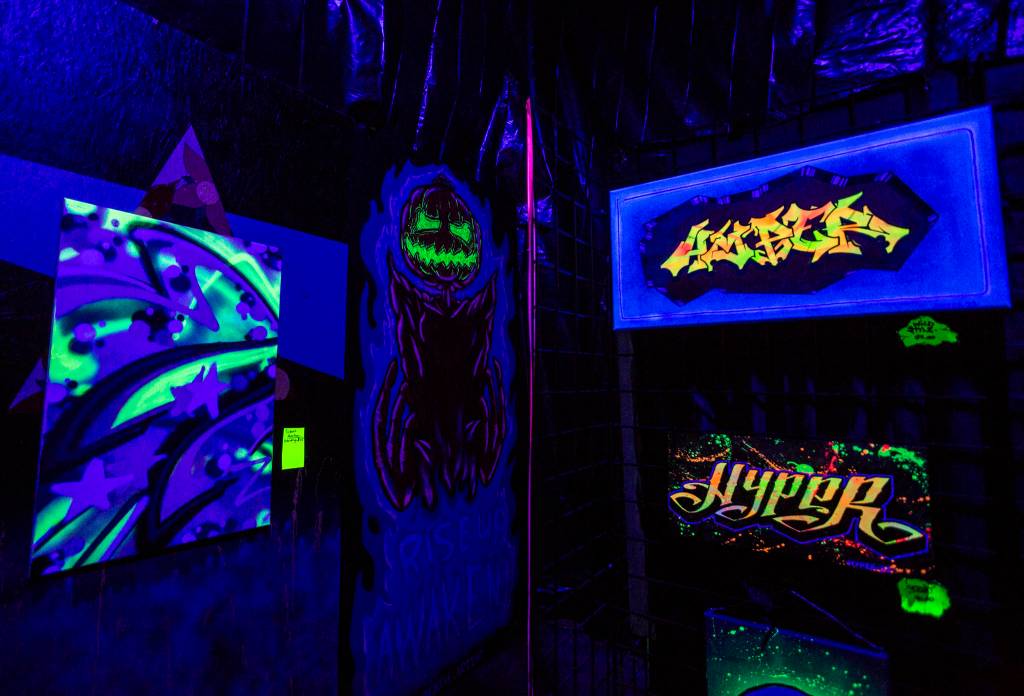 Black-light art at JAG Artworks in Everett. (Olivia Vanni / The Herald)