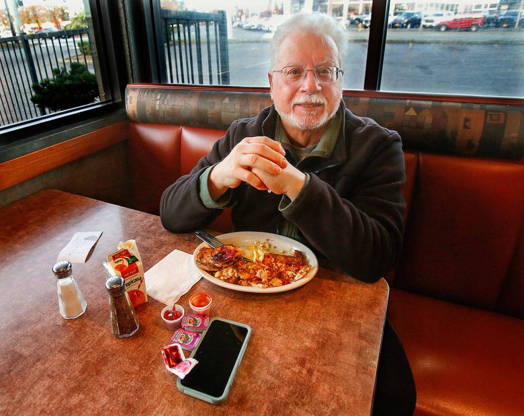 Richard Rauch, 67, of Edmonds, stops in for breakfast at Burgermaster on Evergreen Way in Everett Thursday before going to his job of taking kids to school. Rauch is a regular at the restaurant, which will close permanently on Sunday. (Dan Bates / The Herald)