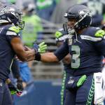 Seahawks quarterback Russell Wilson (3) greets wide receiver Tyler Lockett (16) after Lockett caught a pass from Wilson for a touchdown during the first half of a game against the Ravens on Oct. 20, 2019, in Seattle. (AP Photo/John Froschauer)
