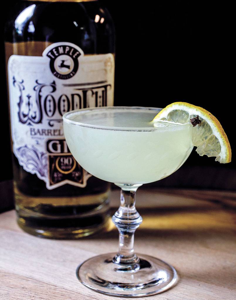 Temple Distillings Winter Revival consists of Woodcut Barrel Rested Gin, lemon juice, clover infused simple syrup and absinthe. (Kevin Clark / The Herald)