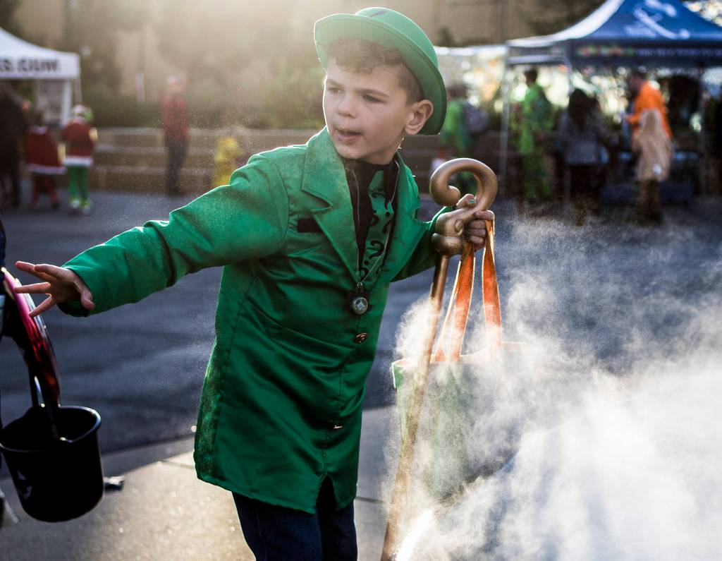 Paxton Jaross, 7, walks by the fountain in Wetmore Plaza during Downtown Trick-or-Treating on Oct. 31, 2019 in Everett, Wash. (Olivia Vanni / The Herald)