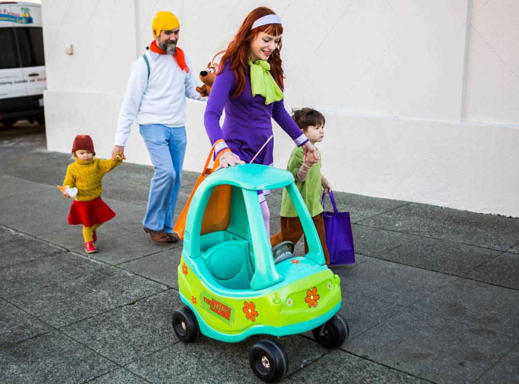 A family dressed as the charters from Scooby Doo walk along California Street during Downtown Trick-or-Treating on Oct. 31, 2019 in Everett, Wash. (Olivia Vanni / The Herald)