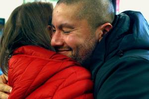 Fernando Moratalla, a U.S. Marine veteran, hugs Myra Rintamaki at the Veterans Resource Center at Edmonds Community College Tuesday. Rintamaki is a Gold Star Mother whose Marine Corps son Steven was killed in Iraq in 2004. Moratalla is an immigrant from Venezuela. (Dan Bates / The Herald)