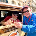 Bill Ward (left) and Lee Harmon share a celebratory champagne toast at the finish line of the 36-day Peking to Paris Motor Challenge.