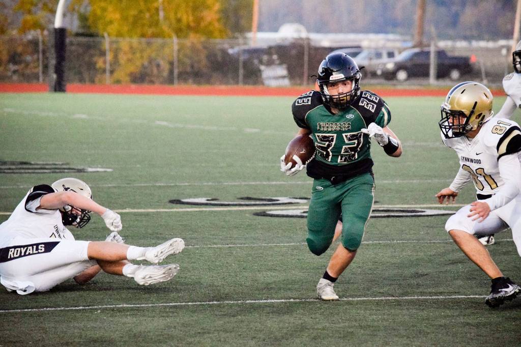 Senior running back Austin Byron runs towards the sideline against Lynnwood on Friday, Nov. 1 at Quil Ceda Stadium in Marysville. (Katie Webber / The Herald)