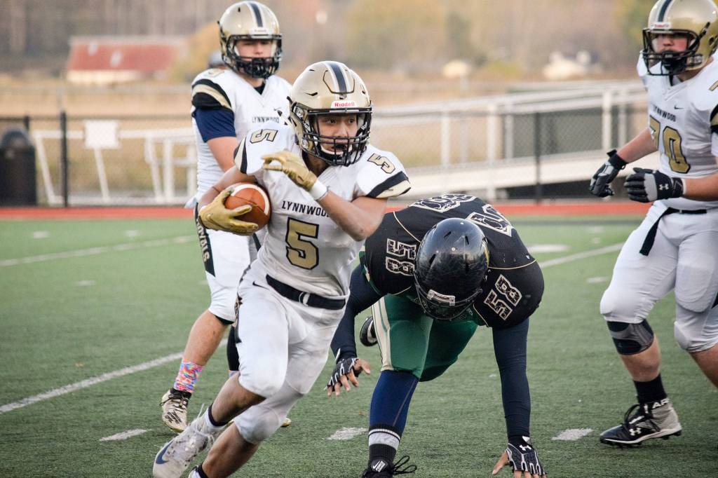 Senior running back Daniel Tran runs towards the Marysville Getchell sideline on Friday, Nov. 1 at Quil Ceda Stadium in Marysville. (Katie Webber / The Herald)