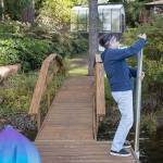 Deb Kocher takes a water level reading off her dock on Lake Crabapple for a Snohomish County lake monitoring program. (Lizz Giordano / The Herald)
